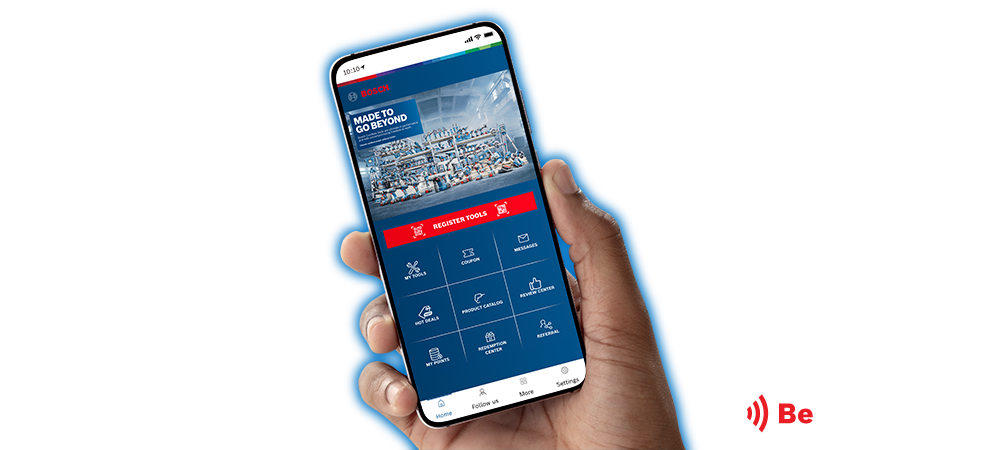 A hand holds a smartphone with the Bosch app on the screen.