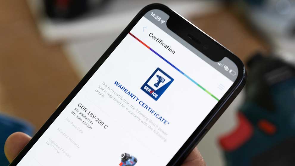 A smartphone displays a Bosch warranty certificate on the screen.