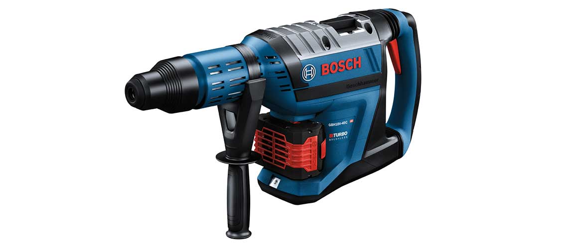 Синий профессиональный перфоратор Bosch лежит на белом фоне.