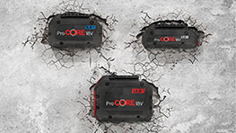 Three black Bosch ProCORE batteries are lying on a brittle concrete floor.
