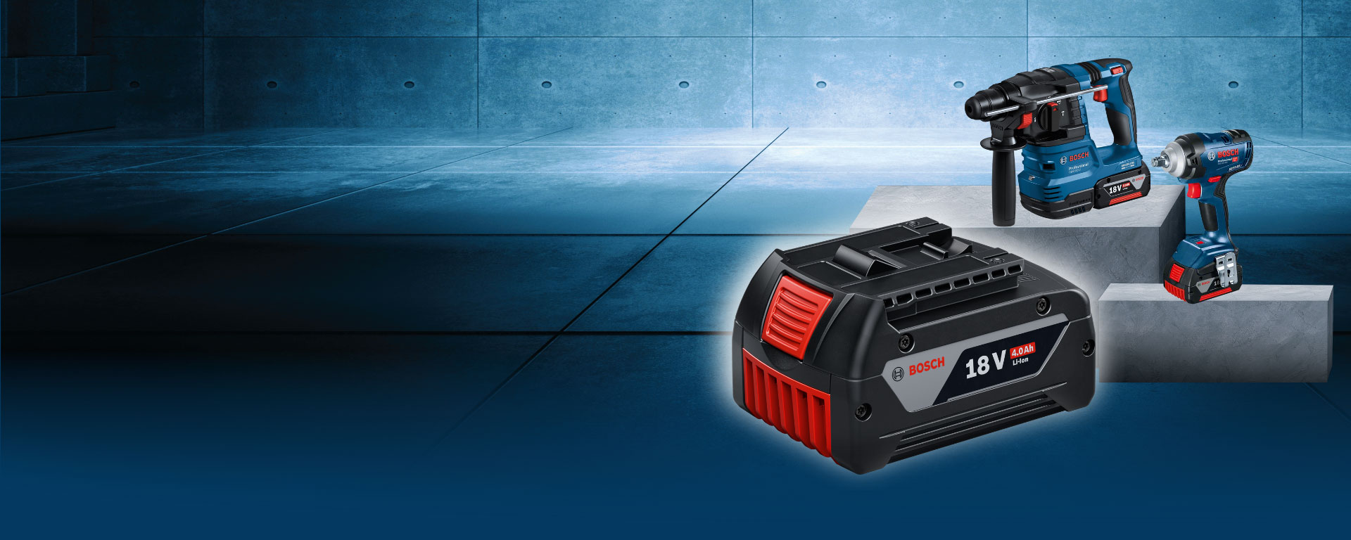 На изображении три инструмента Bosch на сером бетонном полу: аккумулятор, дрель и ударный гайковерт.