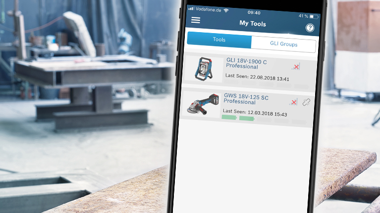 Smartphone shows Bosch Professional tools in workshop environment.