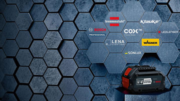 A Bosch Professional cordless tool stands in front of a hexagonal wall.
