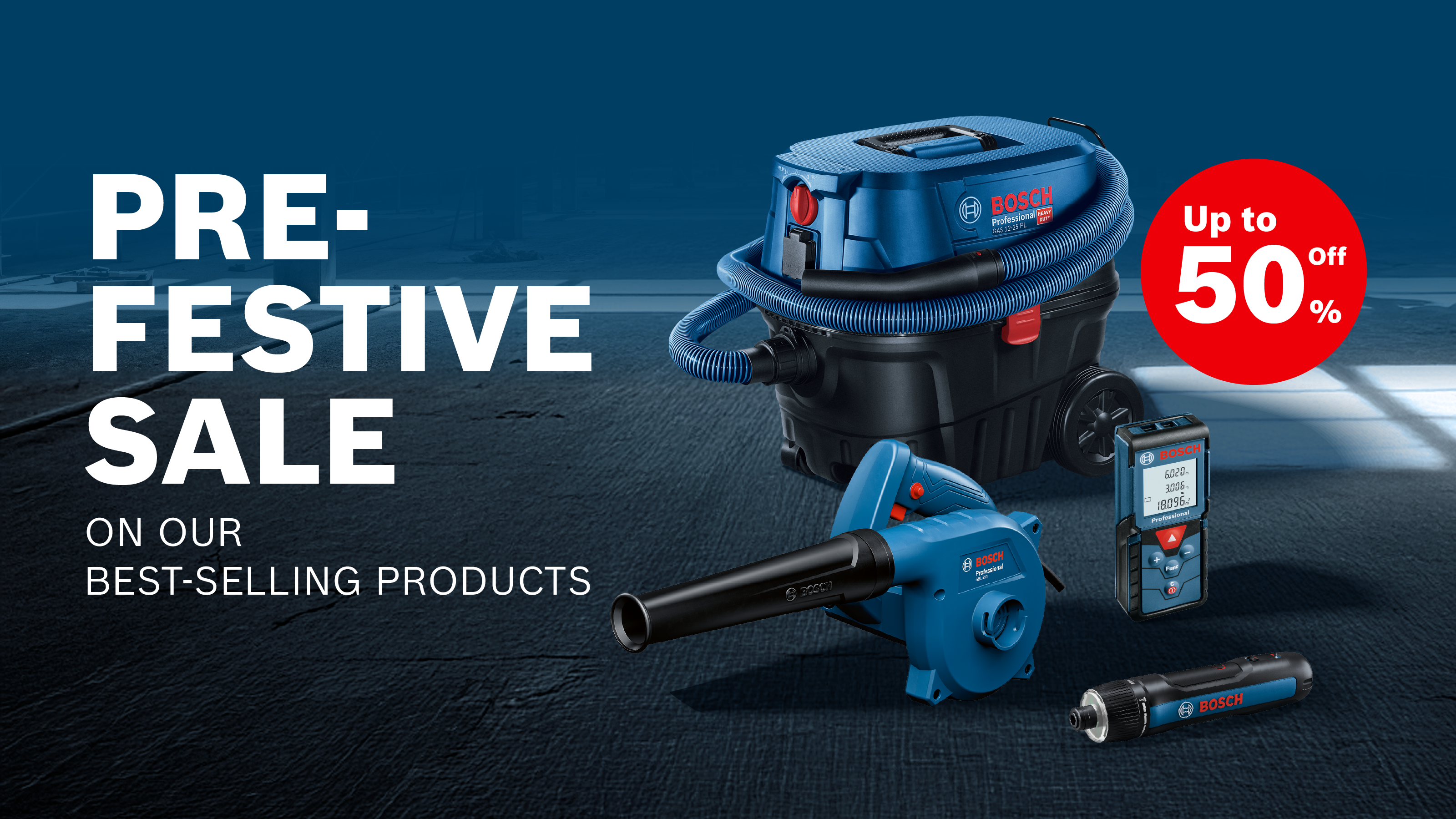 A blue Bosch Professional vacuum cleaner, a blower, a laser distance measurer, and a flashlight are arranged on a dark background. The background shows an industrial setting, and the text "PRE-FESTIVE SALE" highlights a discount of up to 50%.
