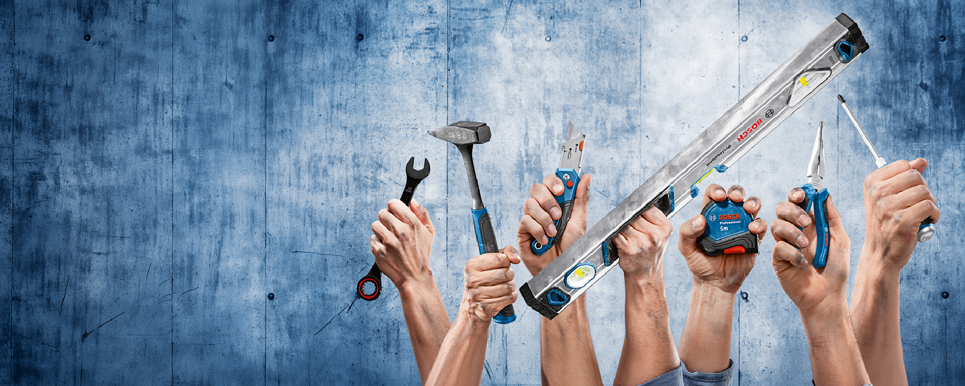 Several hands hold various Bosch Professional tools, including a hammer, a level, and screwdrivers, in front of a blue wall.