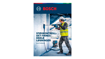 En arbeider med gul vest bruker en Bosch boremaskin i et rom.