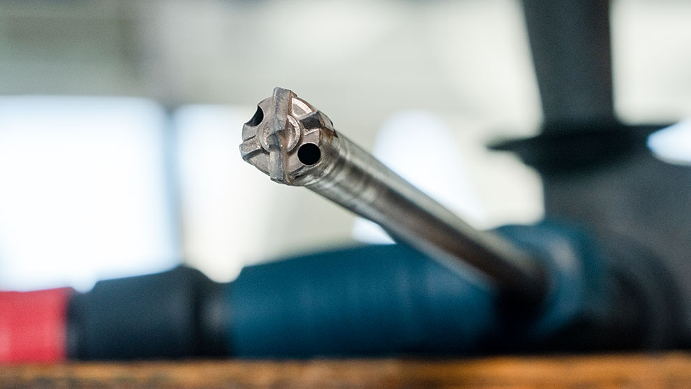 Close-up of a Bosch Professional tool attachment on wood.