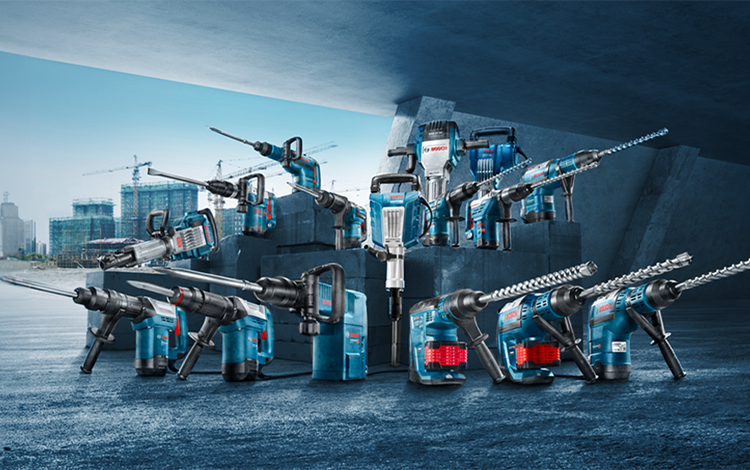 Various Bosch Professional tools on a concrete floor.