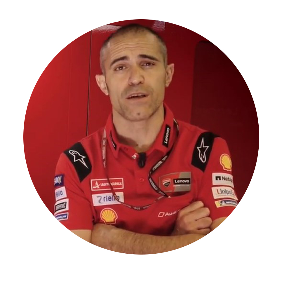 Mees punases särgis seisab punase tausta ees ja räägib.