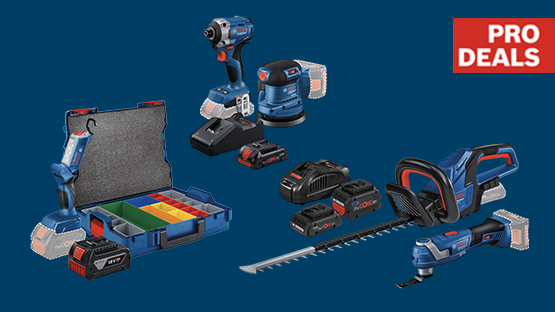 A selection of blue Bosch Professional tools: cordless screwdriver, cordless lawn mower, charger, and batteries, on a dark background.