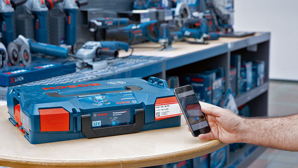 Käsi skaneerib nutitelefoniga Bosch Professional tööriistakasti.