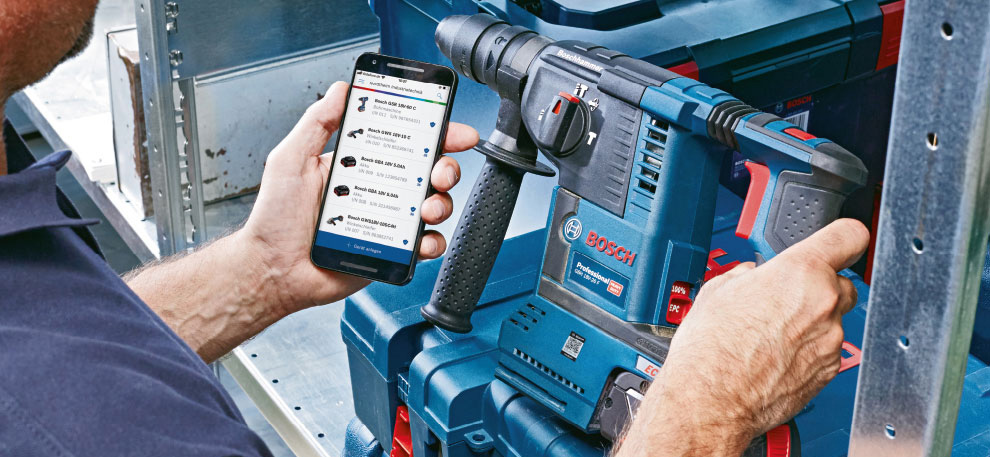 Ett Bosch Professional-verktyg används av en person med smartphone.