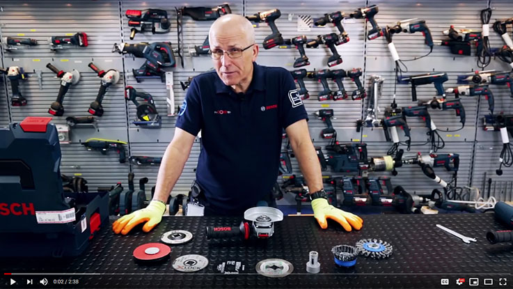 A man explains Bosch Professional tools on a table with accessories.