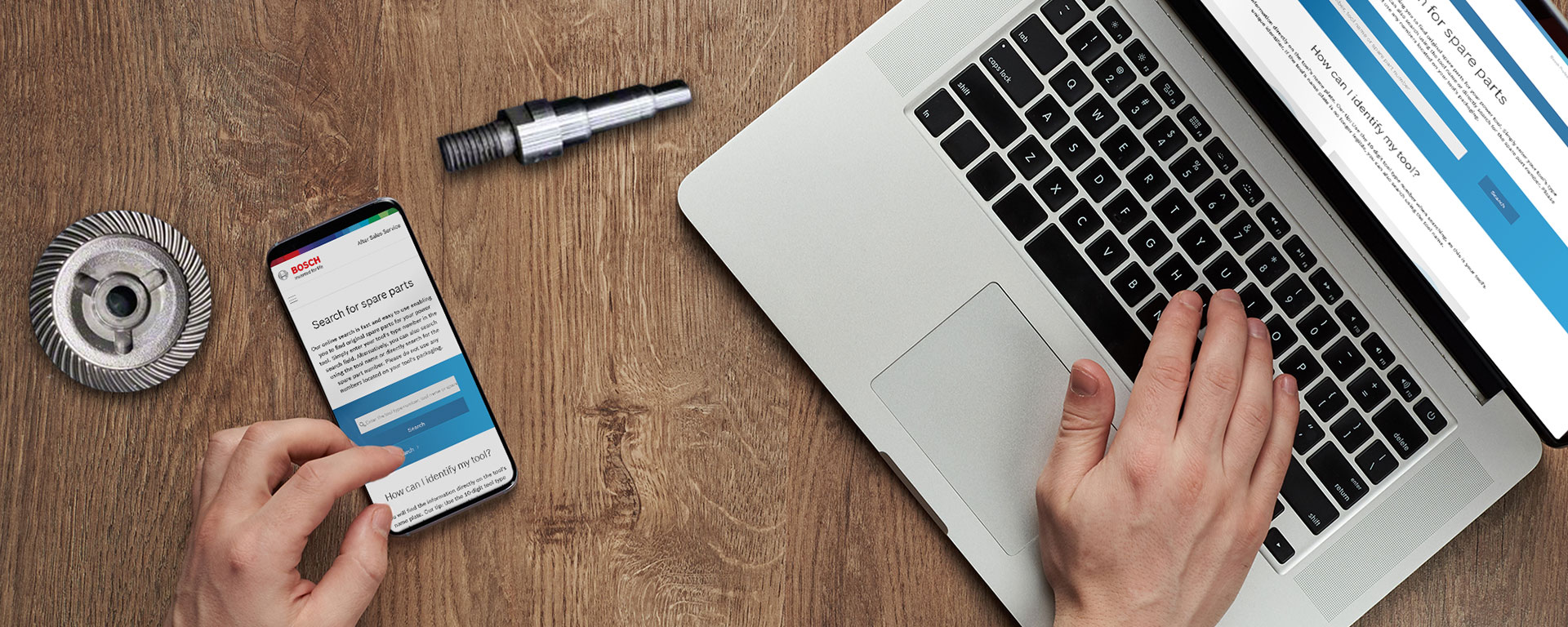 En hånd betjener en bærbar datamaskin og en smarttelefon med Bosch-nettstedet.