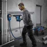 Bosch GBH6-42VB rotary hammer drilling wall.