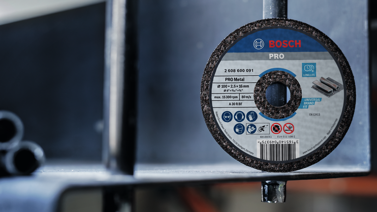 Grinding disc attached to a metal structure in an industrial setting.