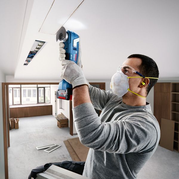 Bosch GOP 185-LI cordless multi-cutter used for ceiling work.