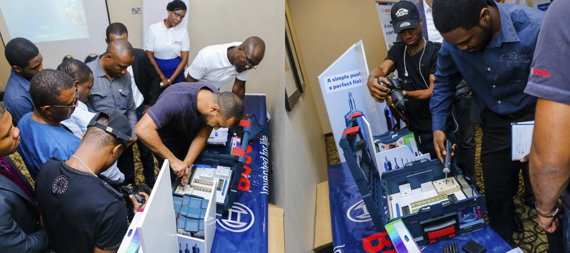Group of people examining Bosch Professional tools at a demonstration event.