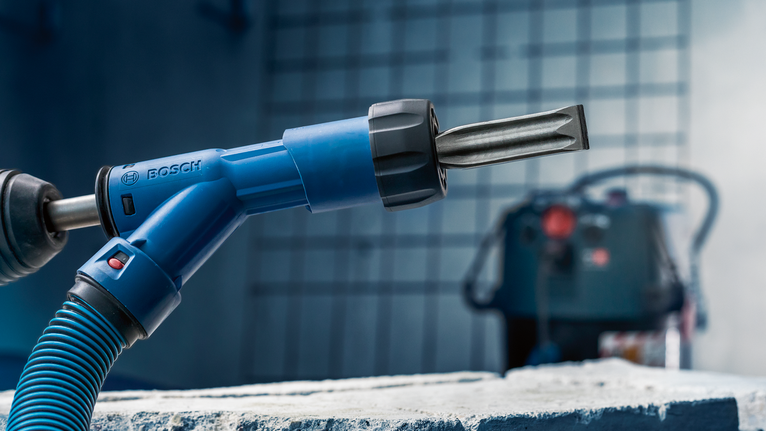 EXPERT SDS Clean max Flat Chisel Adapter 25x400 mm Rotary hammer with chisel attachment positioned over a rough concrete block.