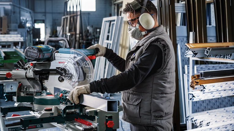 PRO Multi Material Circular Saw Blade, 305 x 3.2 x 30 mm, T80 A person wearing safety equipment operates a miter saw to cut a metal profile.