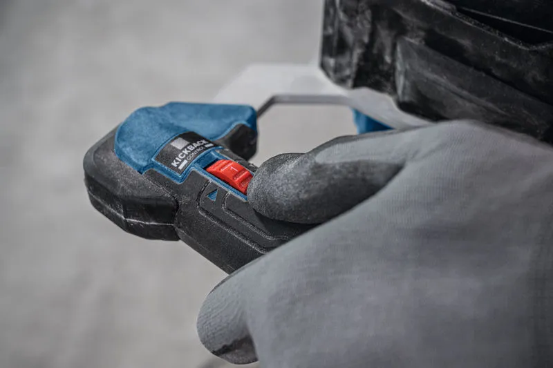 Person wearing safety equipment operates a stirring mechanism with a red control switch.