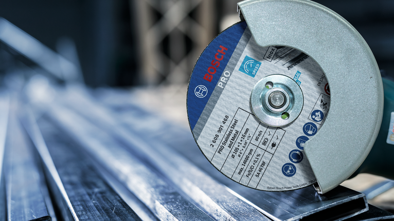 PRO Stainless Steel and Metal Cutting Disc, 105 x 1 x 16 mm A metal cutting tool slices through steel beams in an industrial setting.