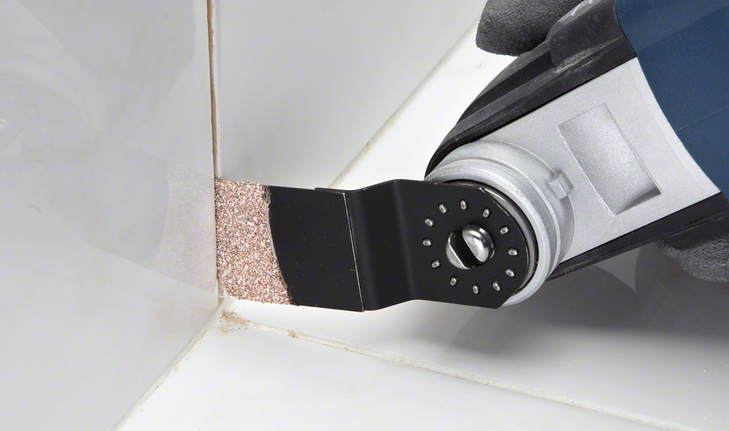 Plunge Cut Saw Blade AIZ 32 RT5 Grout & Abrasive Oscillating tool with a carbide blade removes grout from bathroom tile joints.