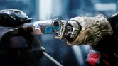 A person wearing safety equipment cuts a metal pipe with a power tool.