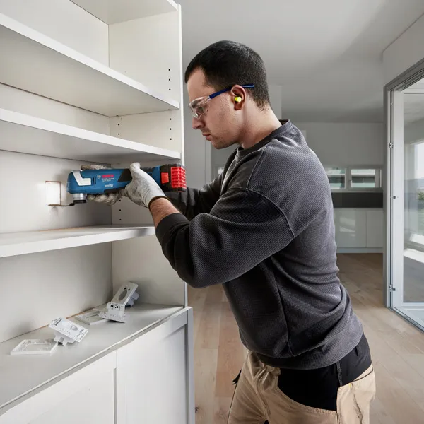 Bosch GOP 185-LI cordless multi-cutter used for shelf installation.