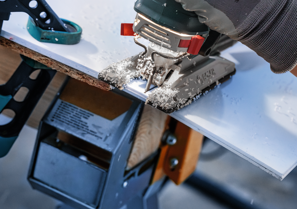 Bosch jigsaw blade cutting laminated board.