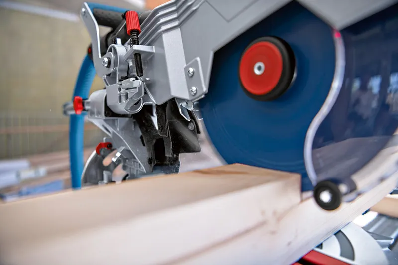 Sladdlös geringssåg som sågar en träbräda i en verkstad.