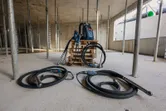 Palet üzerinde iki beton vibratörü ve bir sırt çantası tipi güç kaynağının bulunduğu şantiye.