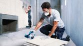 Bosch GDC 140 diamond tile cutter in use.