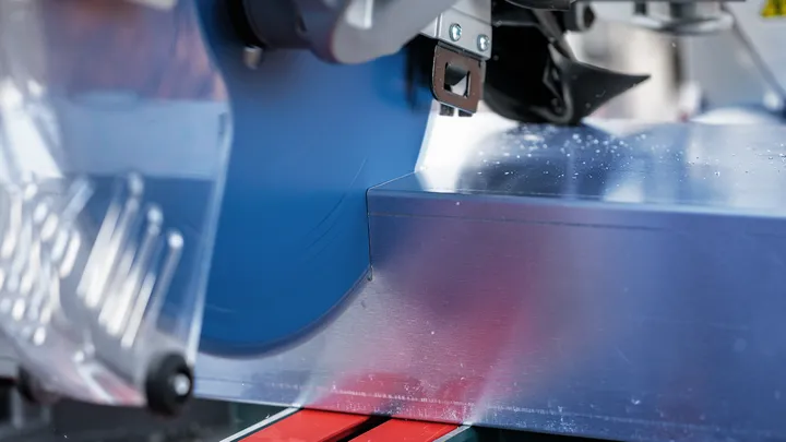 Circular saw cutting through a sheet of metal.
