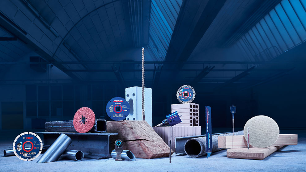 Bosch Professional tools arranged on a dark surface, featuring blades and materials.